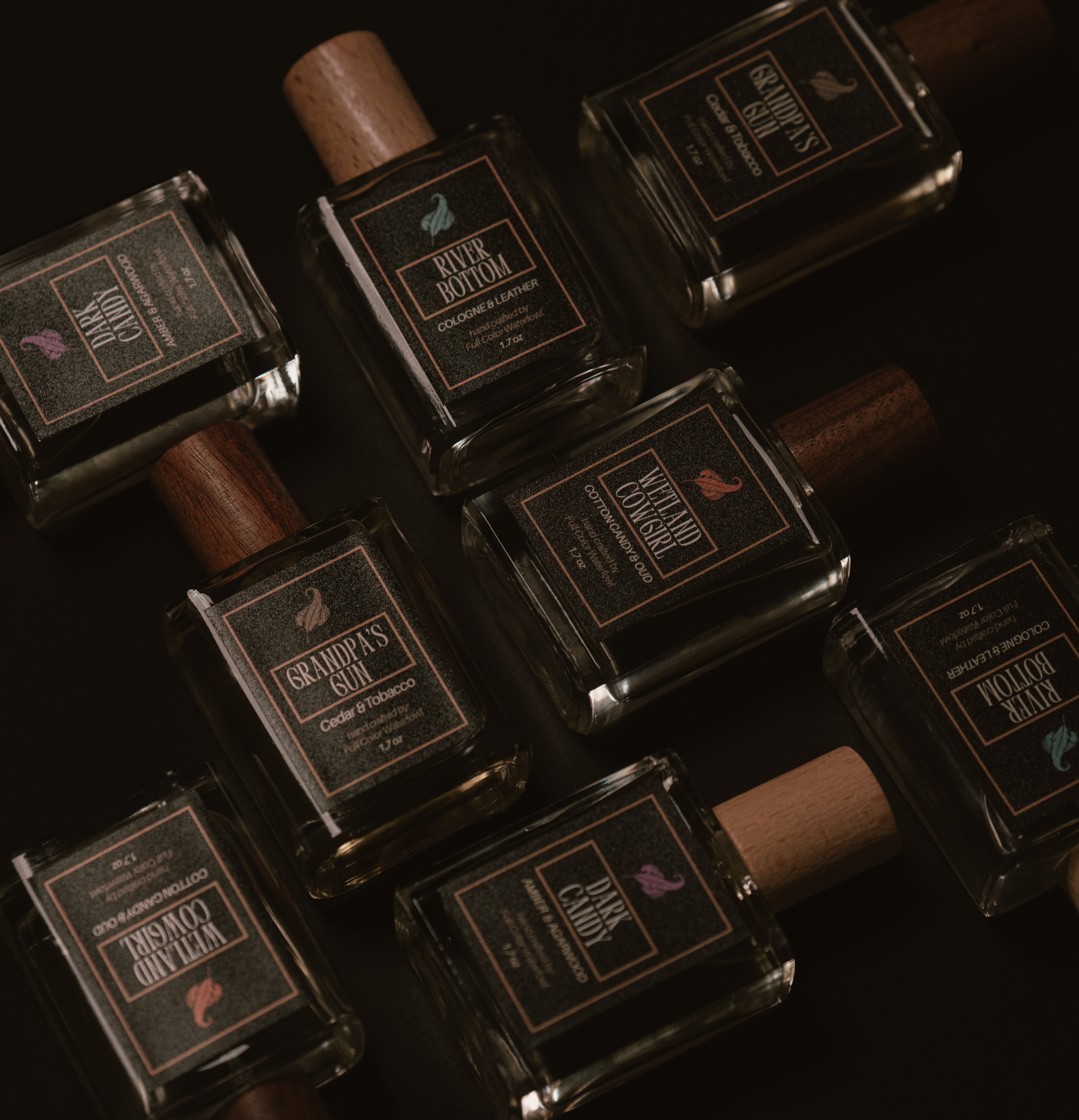 Collection of colognes by Full Color Waterfowl, visible labels River Bottom, Grandpa's Gun, Wetland Cowgirl, Dark Candy