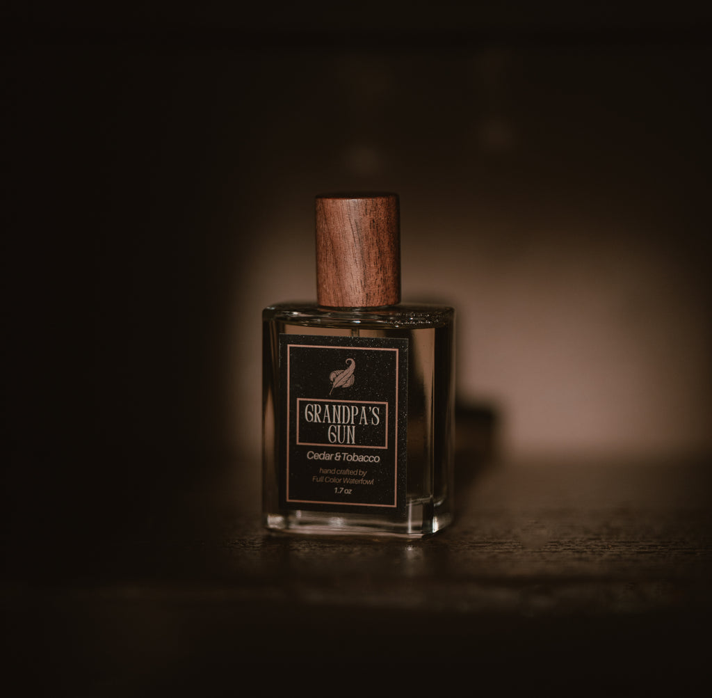 Bottle of 'Grandpa's Gun' with wooden cap on a dark background 