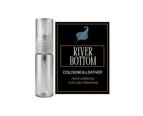 Clear spray bottle with 'River Bottom' cologne & leather packaging on a white background