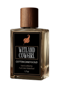 Perfume bottle labeled 'Wetland Cowgirl' with a wooden cap on a white background