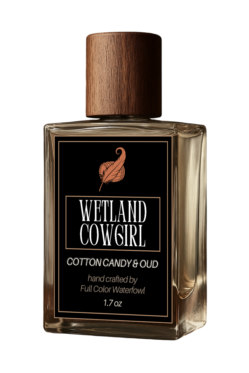 Perfume bottle labeled 'Wetland Cowgirl' with a wooden cap on a white background